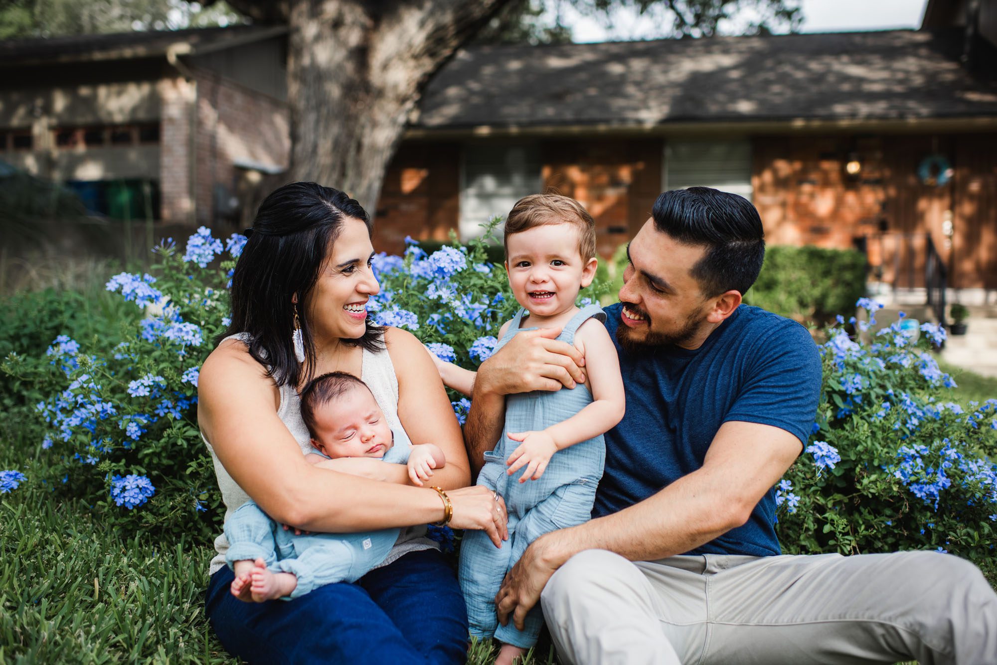 Family with newborn baby smiling at son, San Antonio newborn photographer