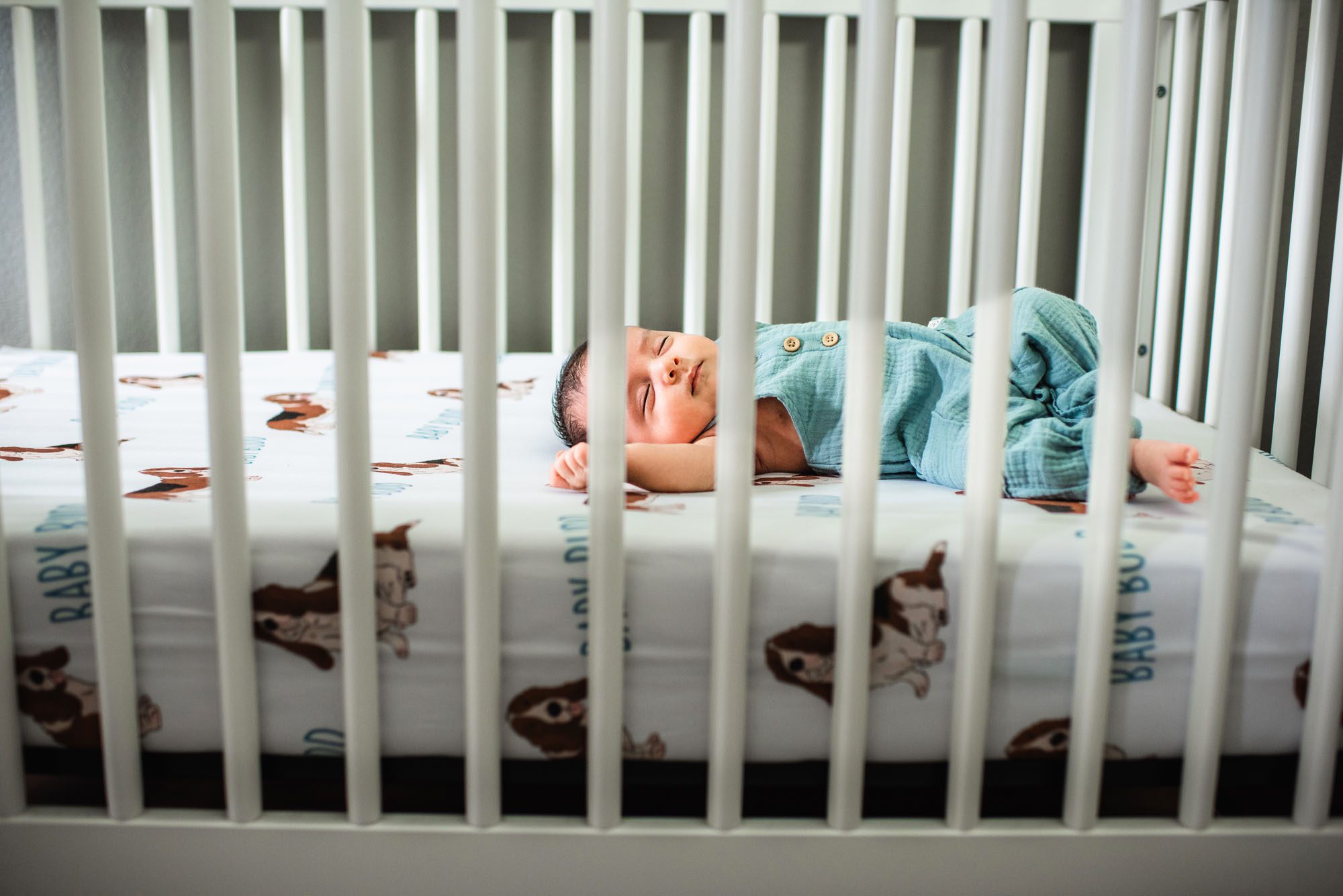 Newborn baby sleeping in crib, best San Antonio newborn photographer