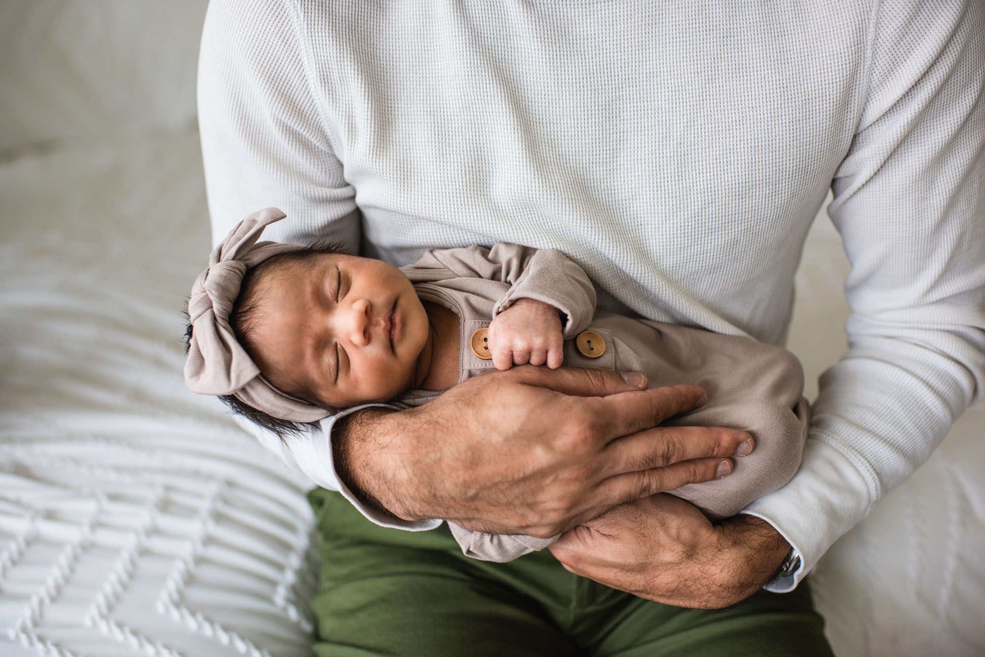 Newborn girl in father's arms, San Antonio lifestyle newborn photographer