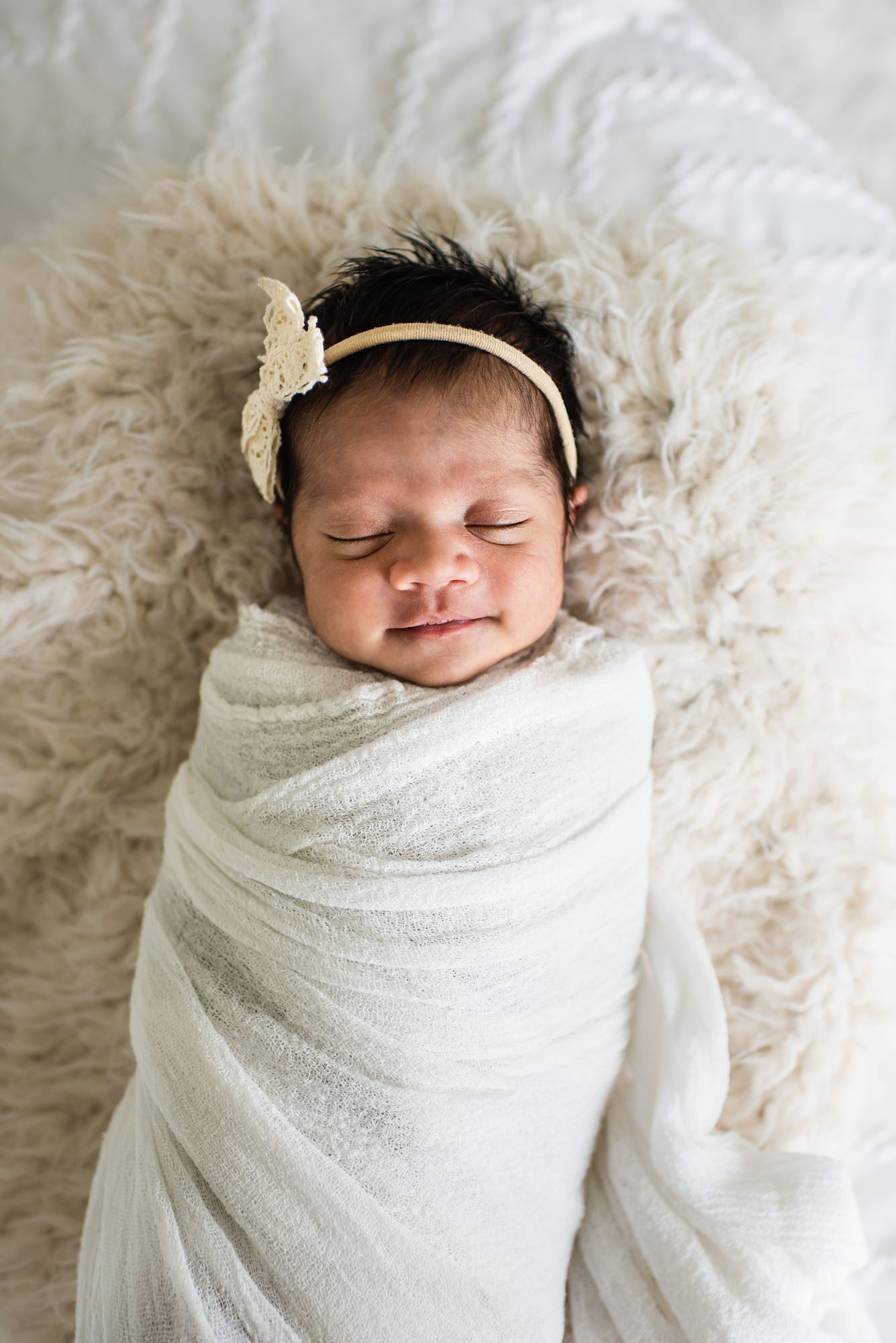 Newborn baby smiling in basket asleep, San Antonio Newborn Photographer