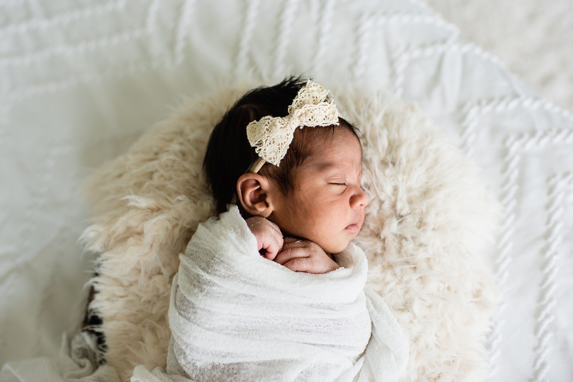 San Antonio Newborn Photographer, newborn baby asleep in basket on white bed