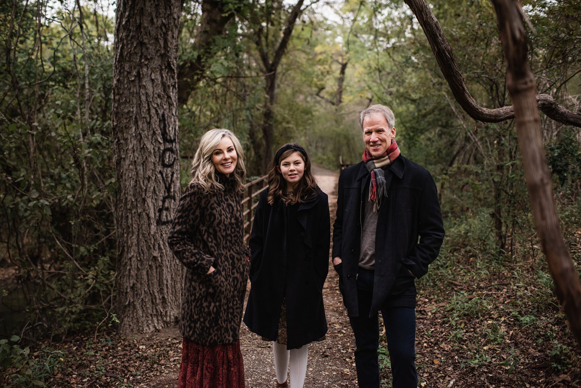 Family standing in woods with coats on, San Antonio family photographer