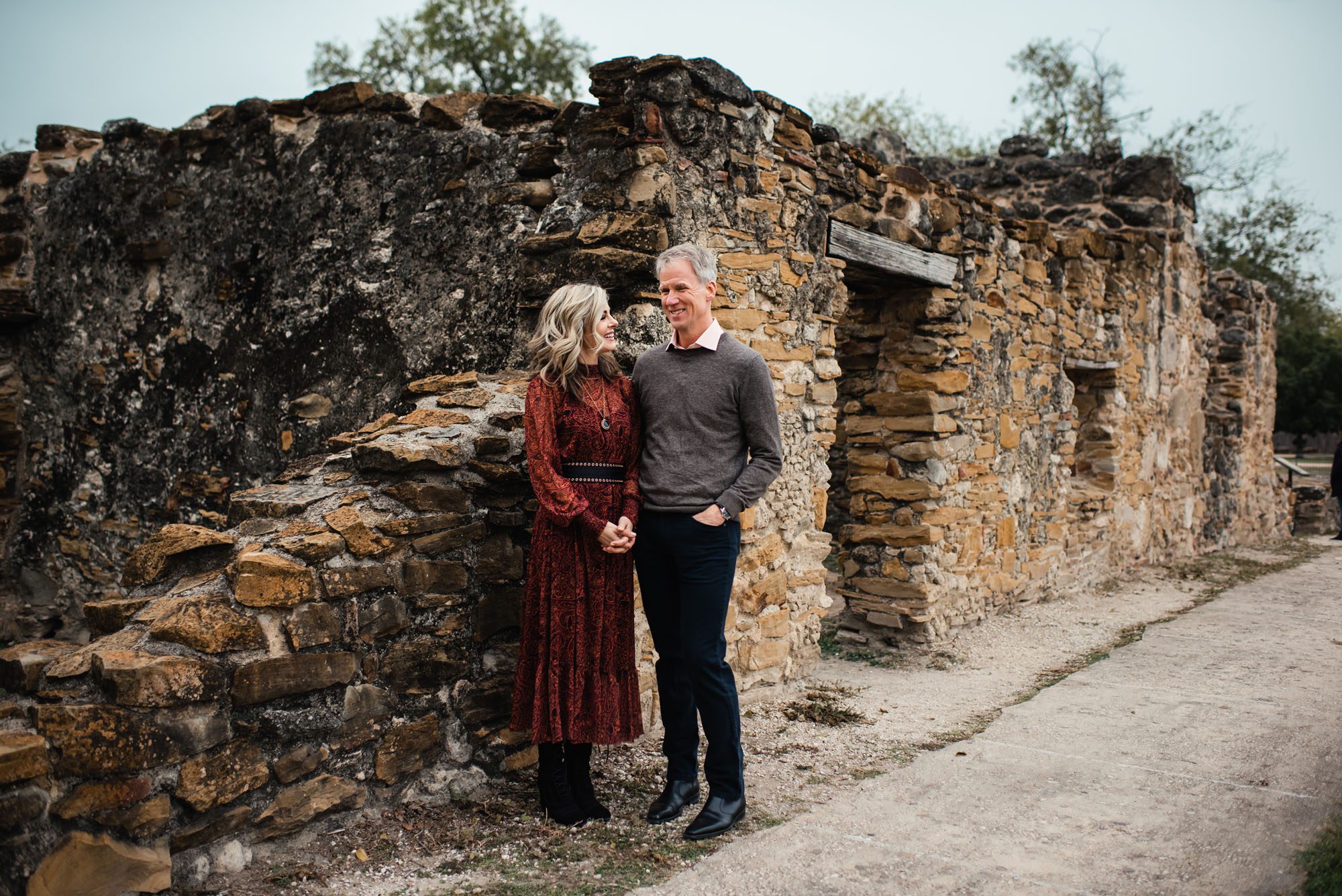 Couple talking by stone wall, San Antonio family photographer