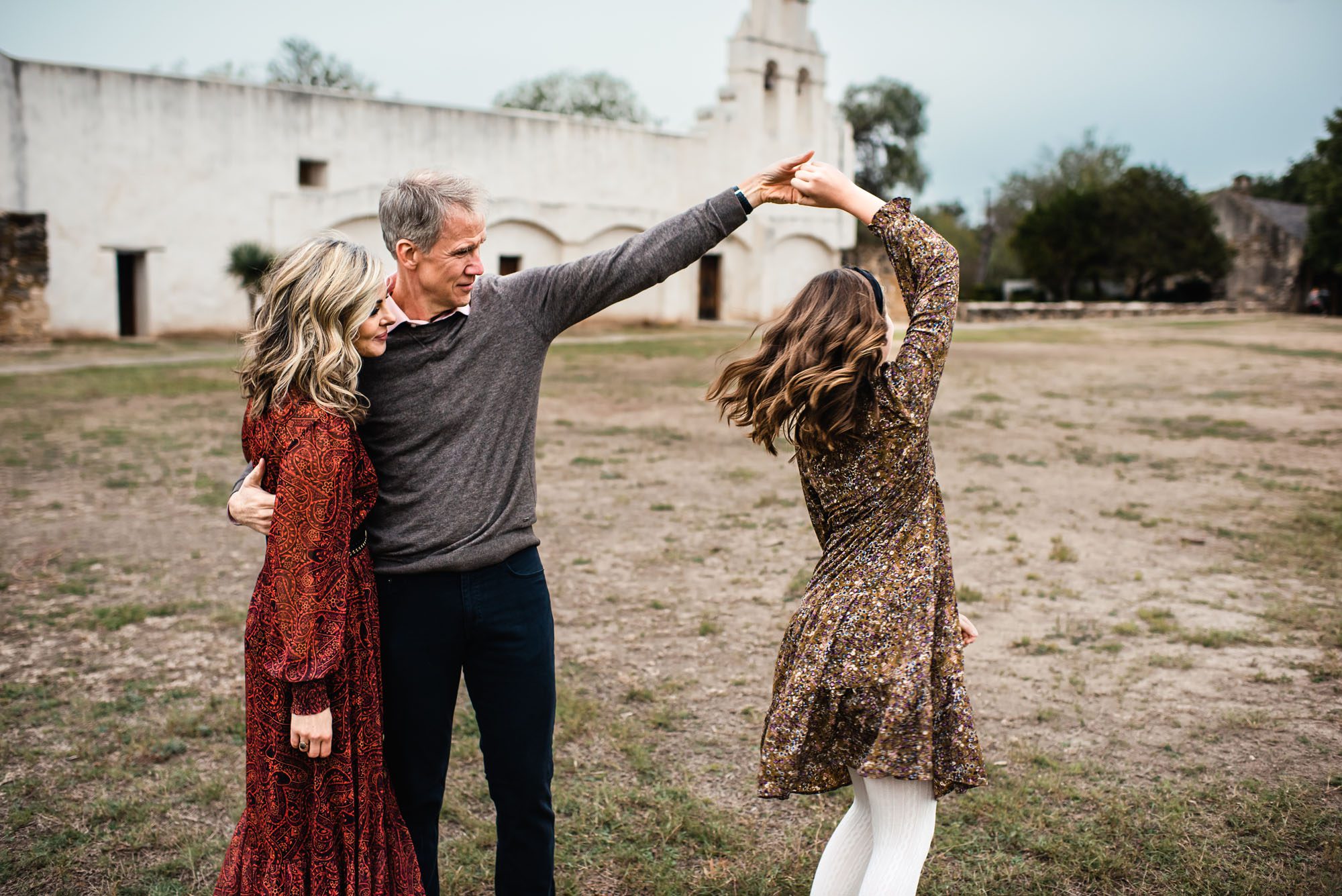 Father twirling daughter in front of San Antonio mission, San Antonio lifestyle photographer