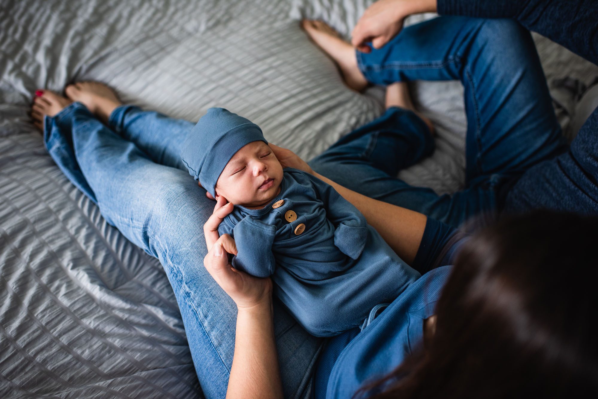 Newborn baby laying on mother's lap, San Antonio Lifestyle Newborn Photographer