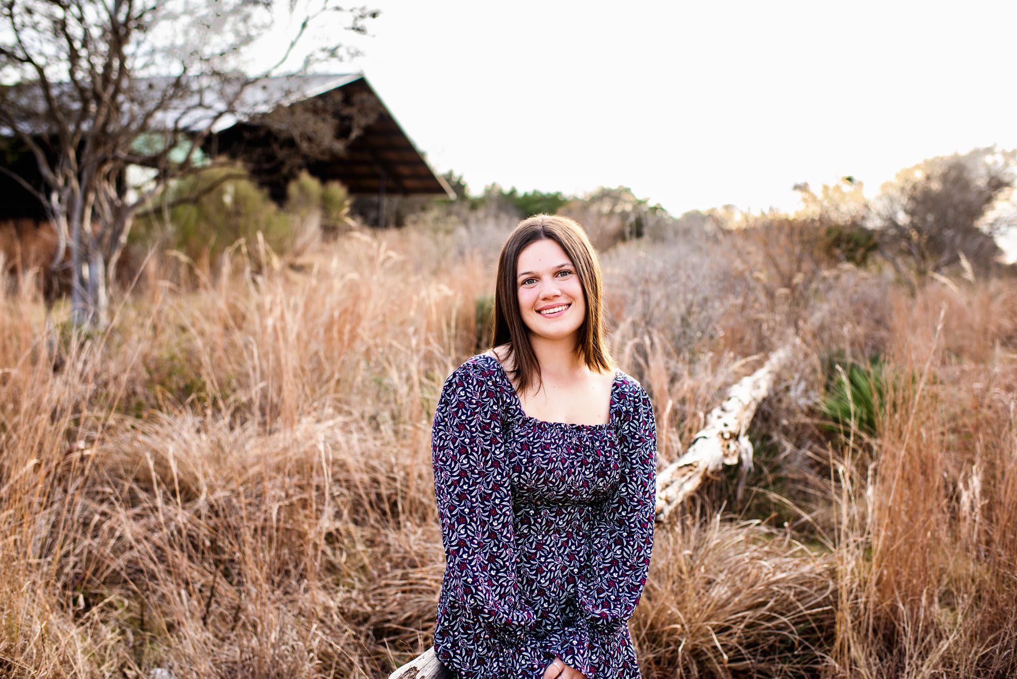 Senior girl standing in tall grasses in a field, San Antonio senior photographer