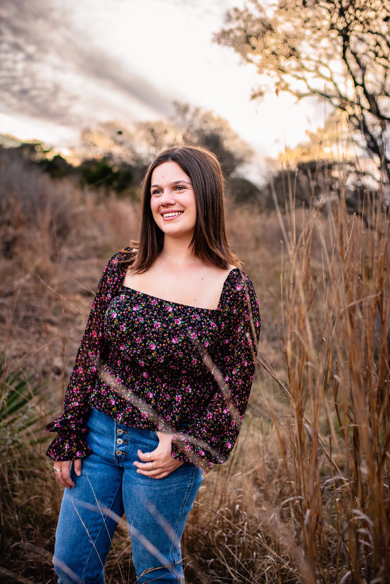 Senior girl smiling in a field, San Antonio senior portrait photographer