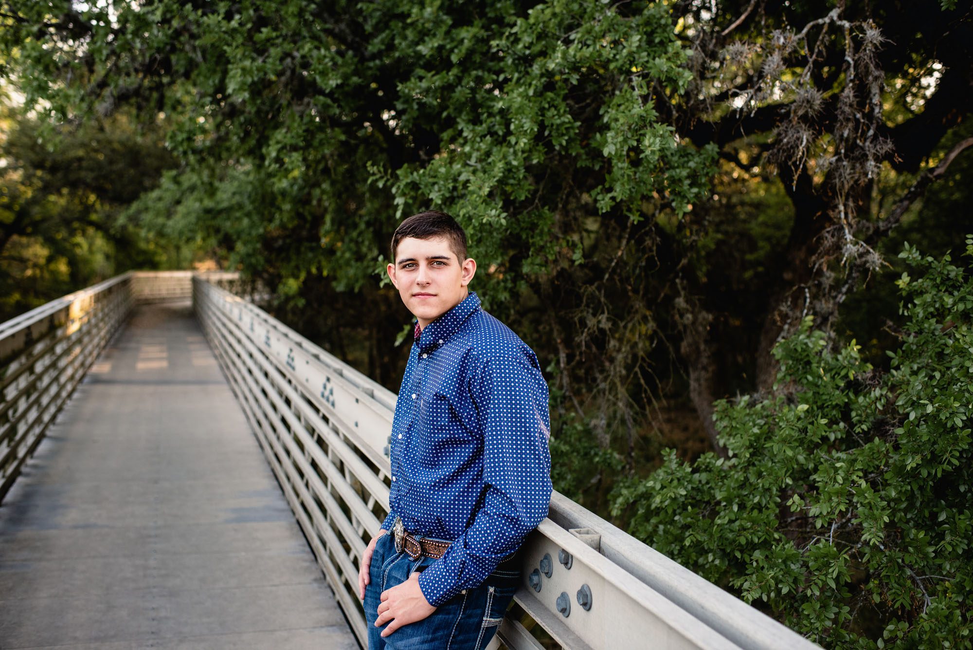 Boy leaning against a bridge, San Antonio senior portrait photographer