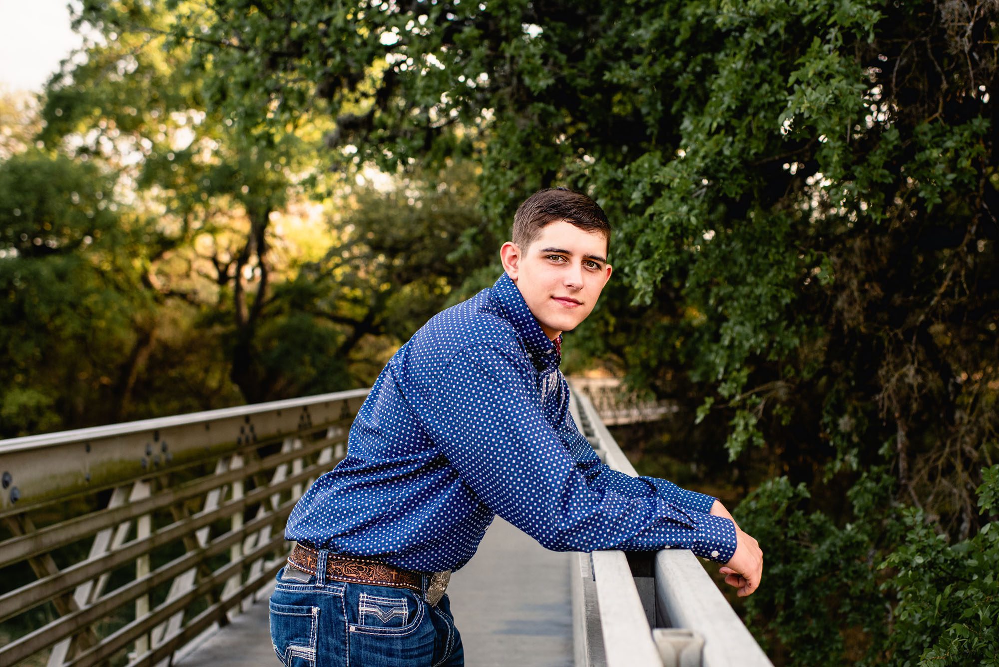 Boy leaning by a bridge, San Antonio senior photographer