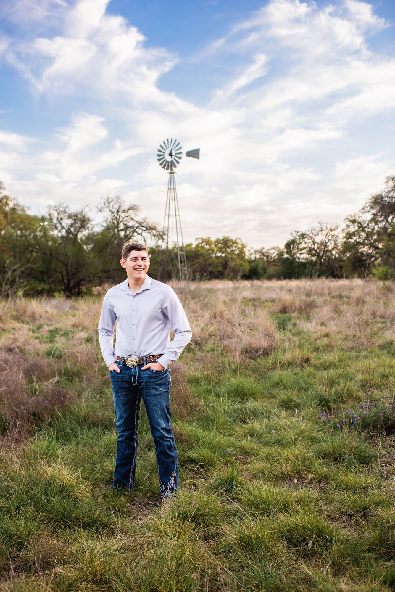 Senior boy standing by a windmill, San Antonio senior photographer