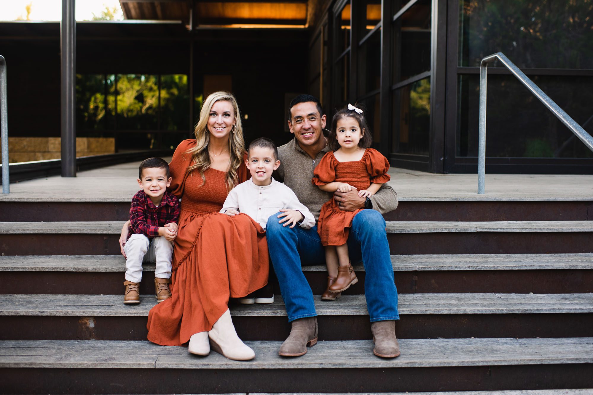 Family sitting on wooden stairs, San Antonio family photographer