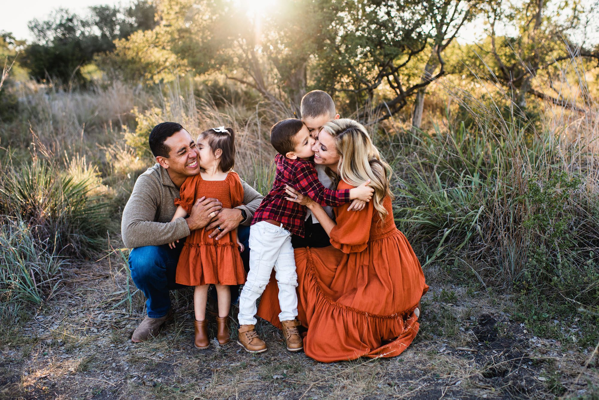 Family hugging each other in the grass, San Antonio lifestyle photographer
