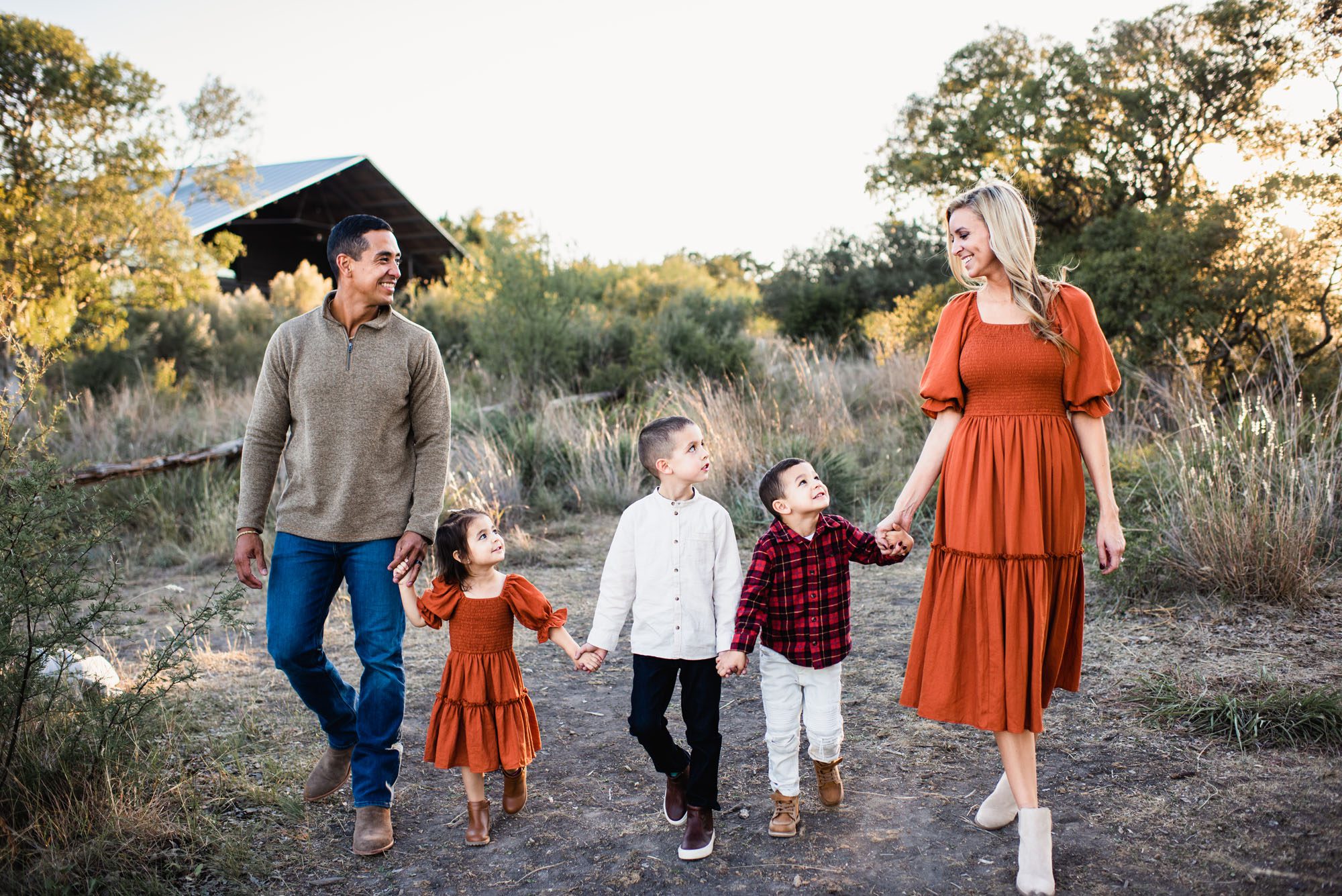 Family holding hands in a field, San Antonio lifestyle photographer