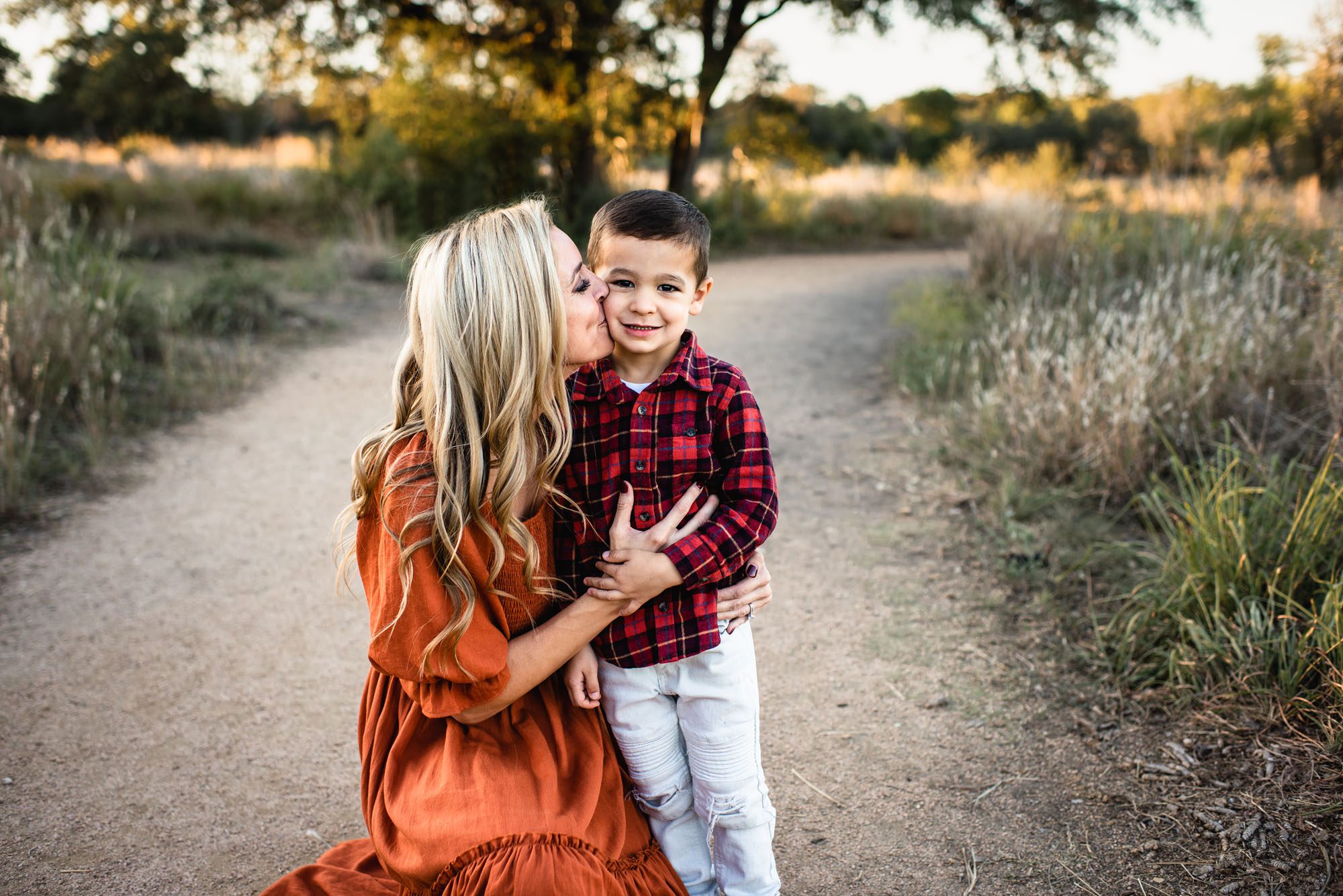 Mother kissing son's cheek, San Antonio lifestyle photographer