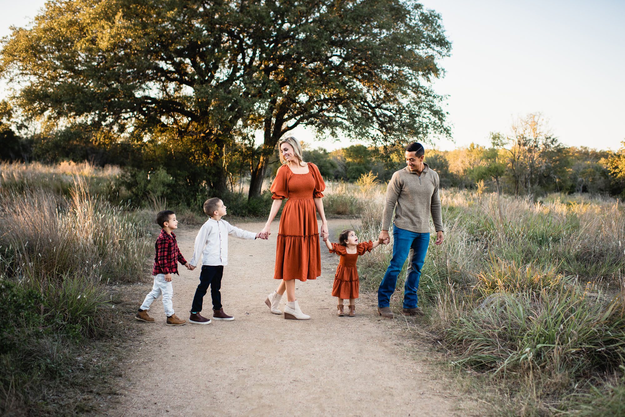 Family walking on a path holding hands, San Antonio family photographer