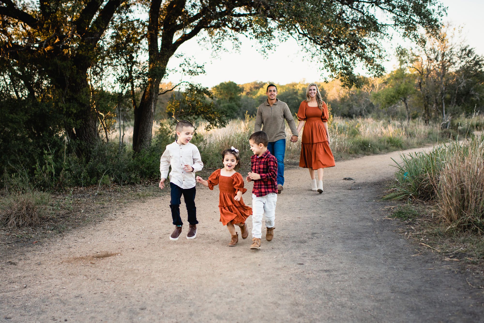 Kids walking on a path with parents, San Antonio family lifestyle photographer