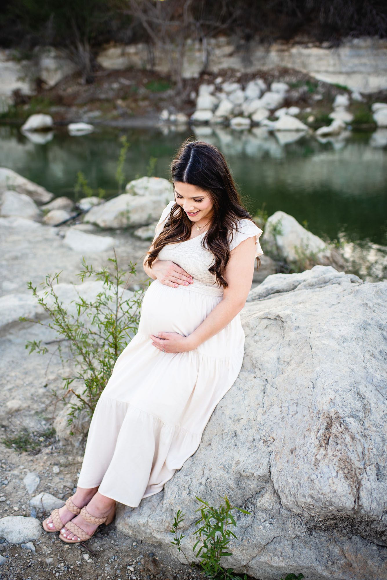 Mother looking at her baby bump, San Antonio lifestyle maternity photographer