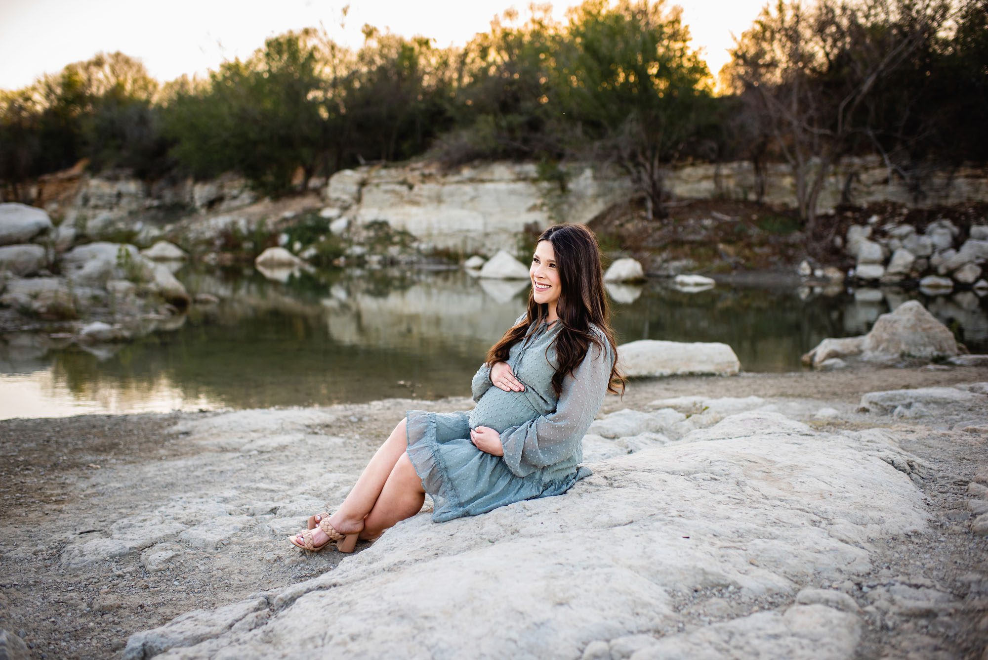 Pregnant mom sitting near a lake, Maternity photographer in San Antonio