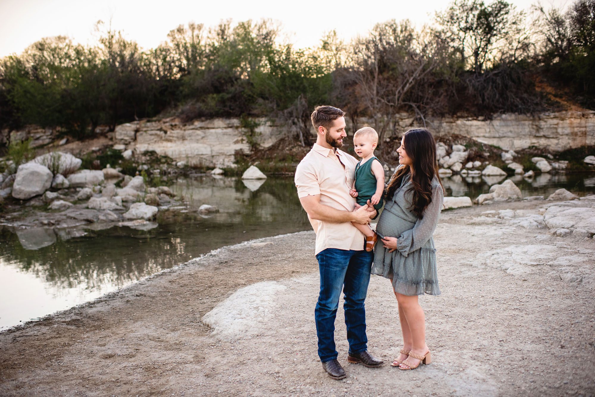 Family standing by a pond, San Antonio maternity photographer