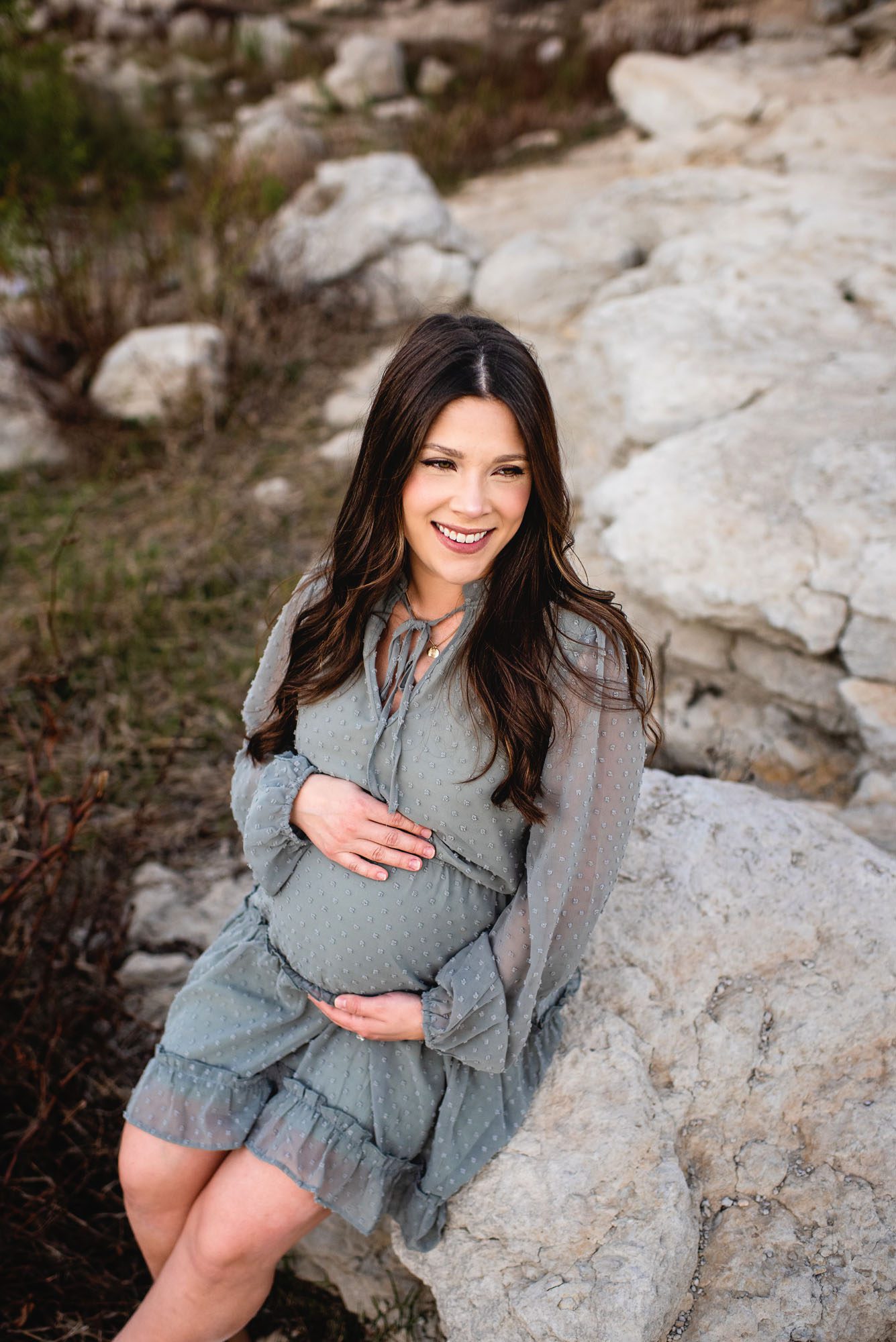 Expectant mother sitting on a rock, San Antonio maternity photographer