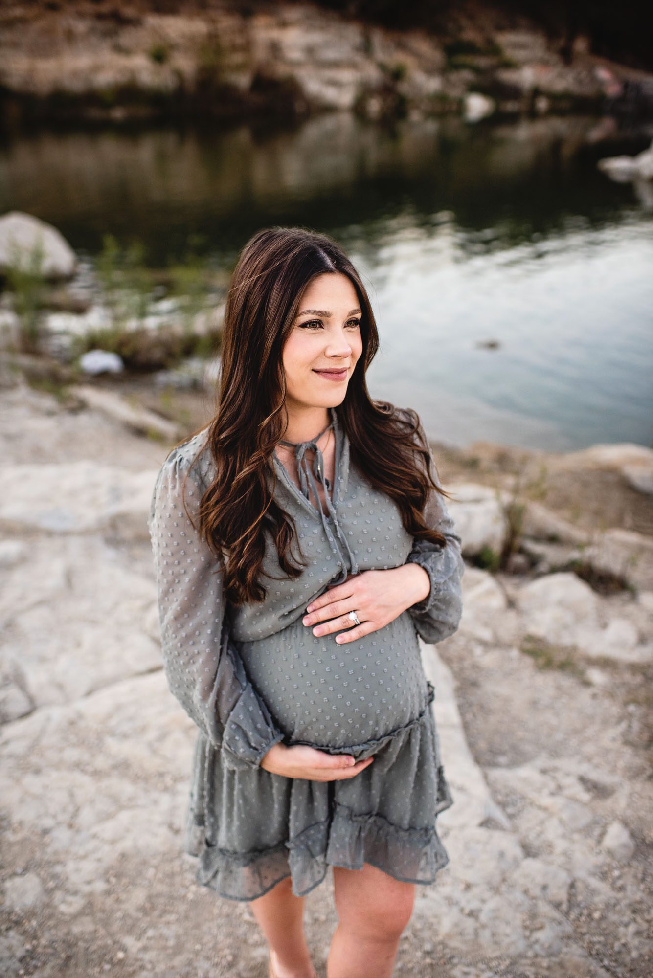 Expectant mother standing by a pond, San Antonio maternity photographer