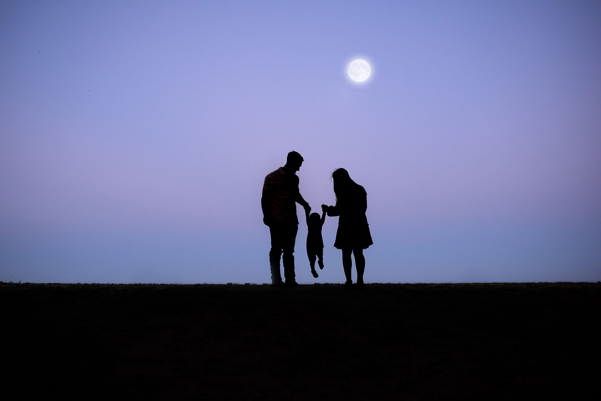 Moonlight silhouette of family walking together, San Antonio lifestyle family photographer
