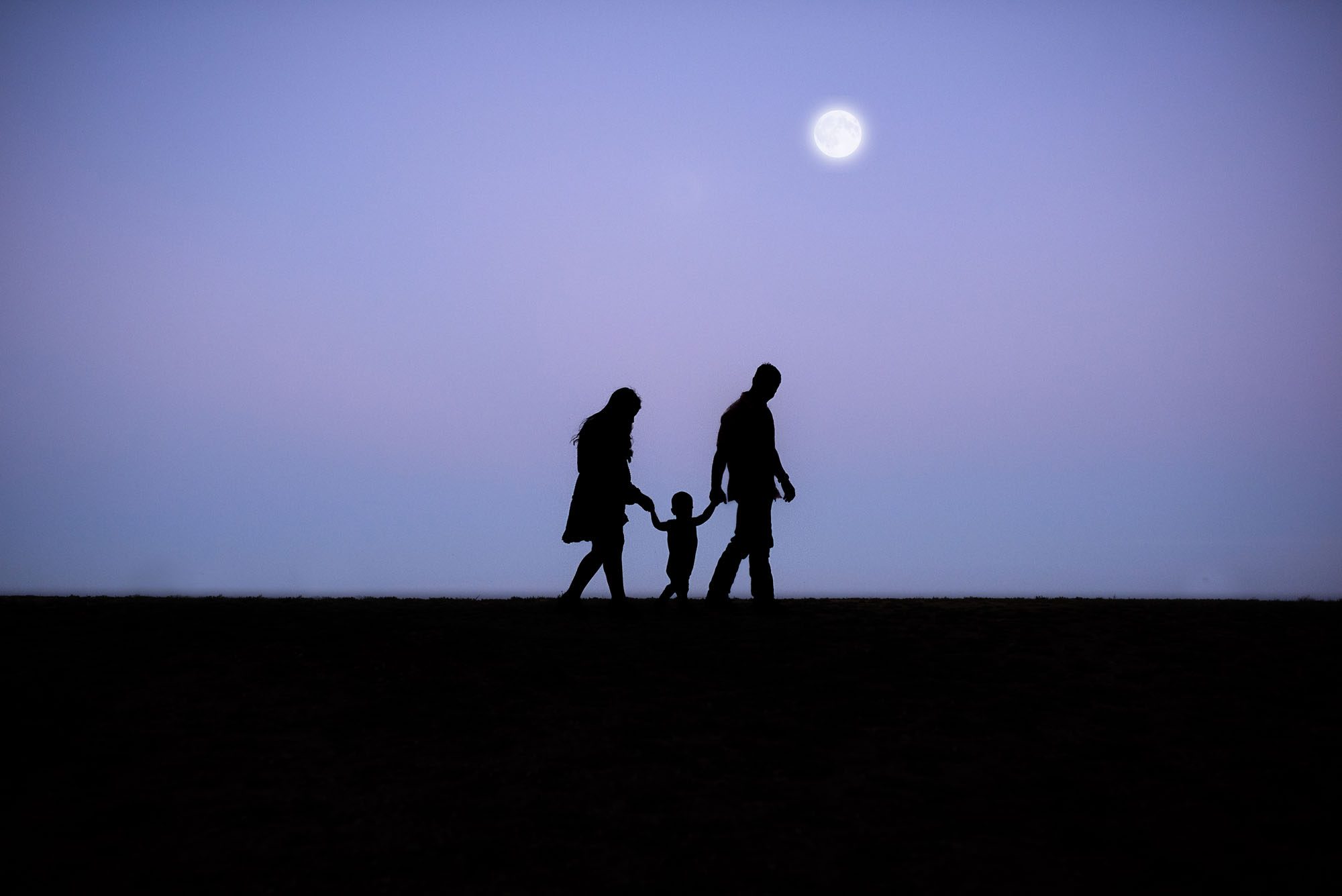Silhouette of family walking under the moon, San Antonio lifestyle family photographer