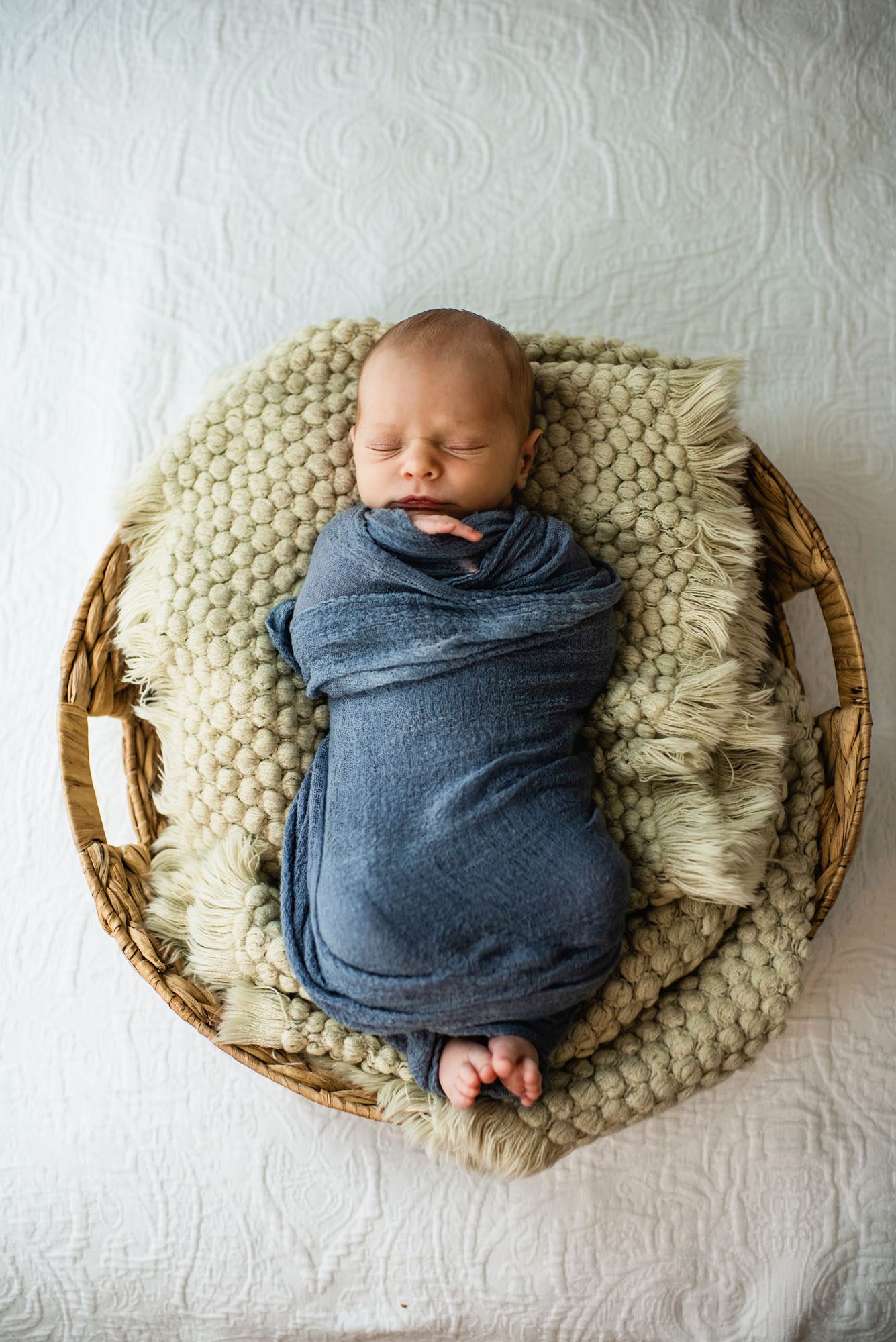 Photo of sleeping baby swaddled in basket, San Antonio newborn baby photographer
