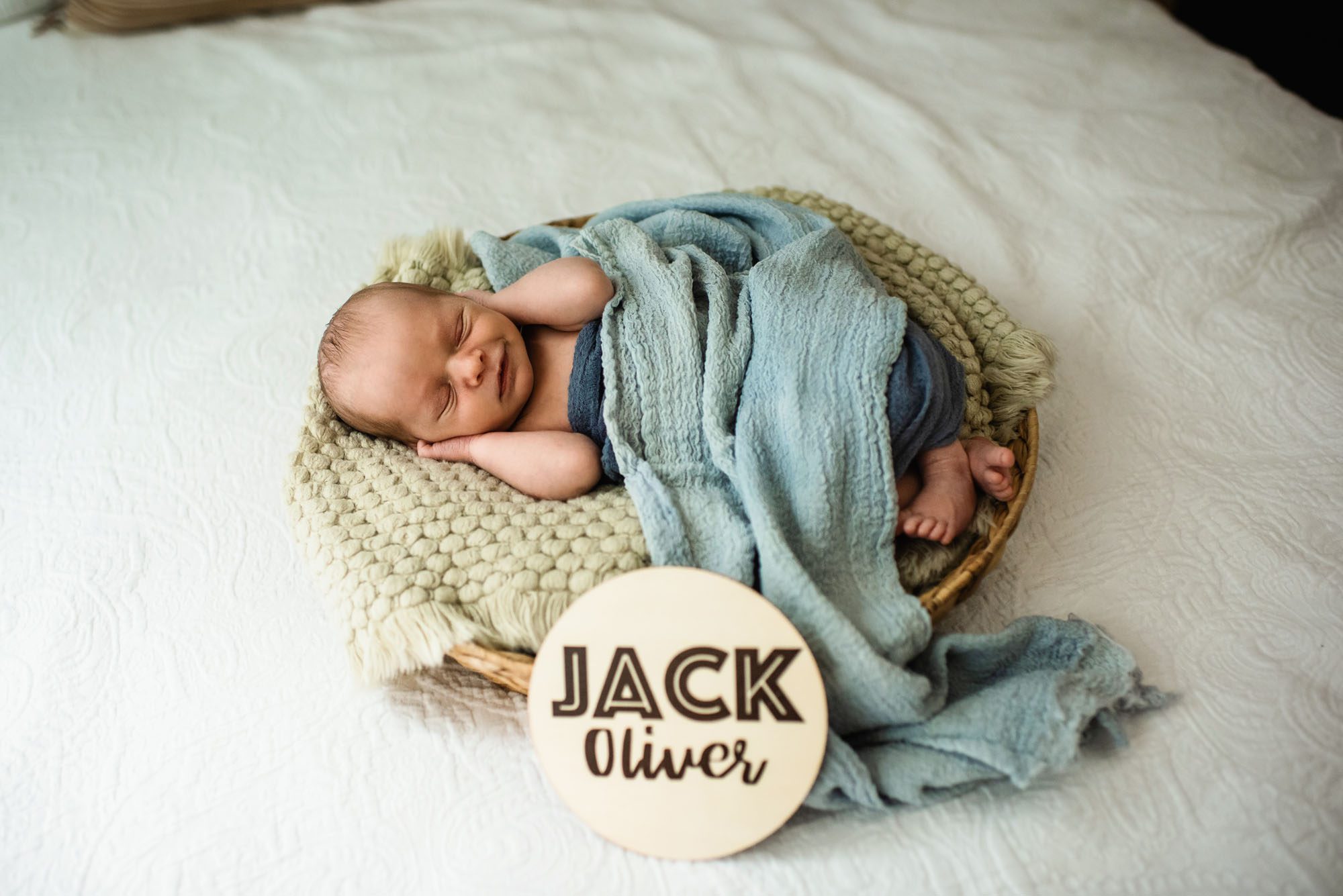 Baby boy posed in basket with blue blankets, San Antonio Newborn Photographer