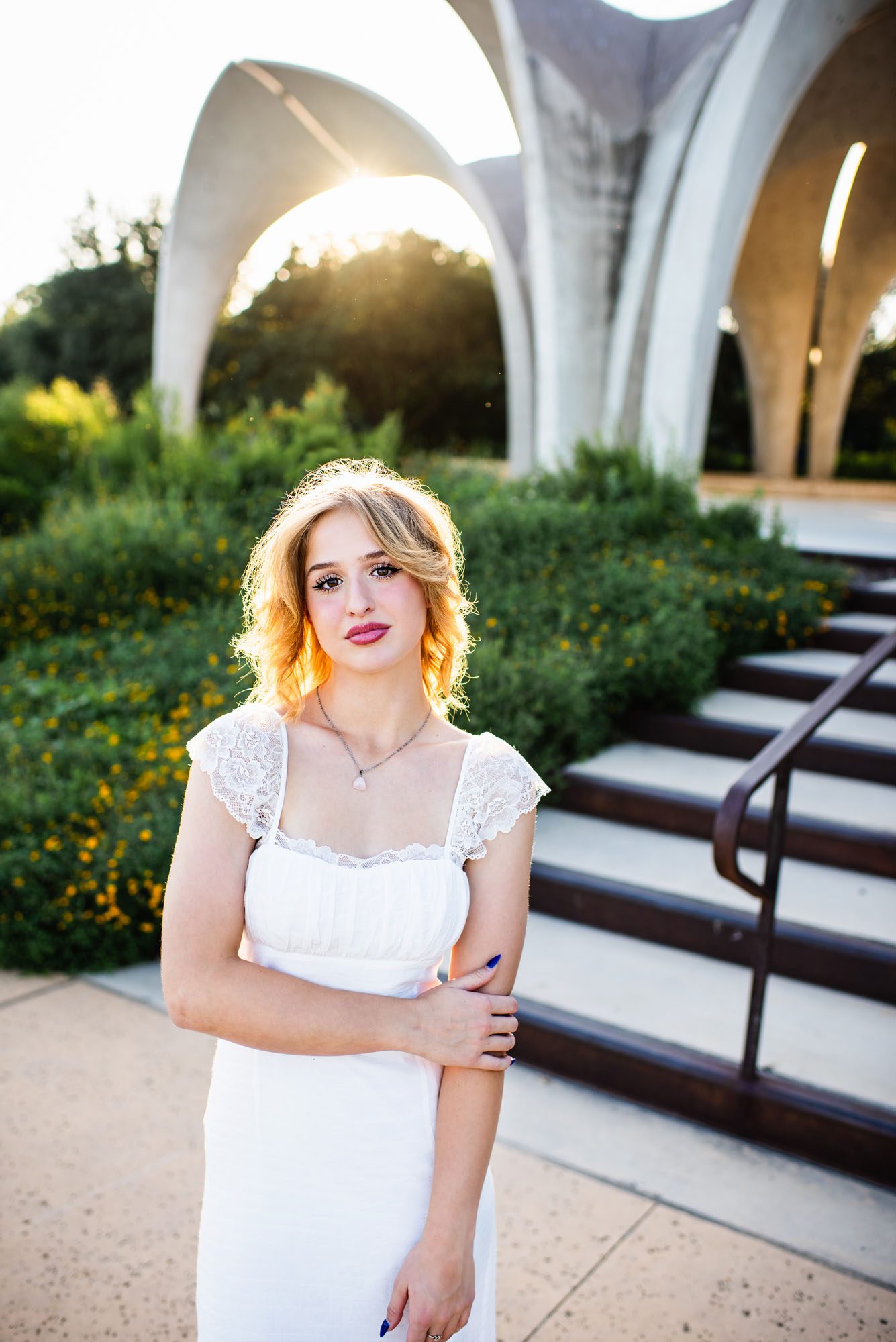 Senior girl in white dress standing by pavilion, San Antonio senior portraits
