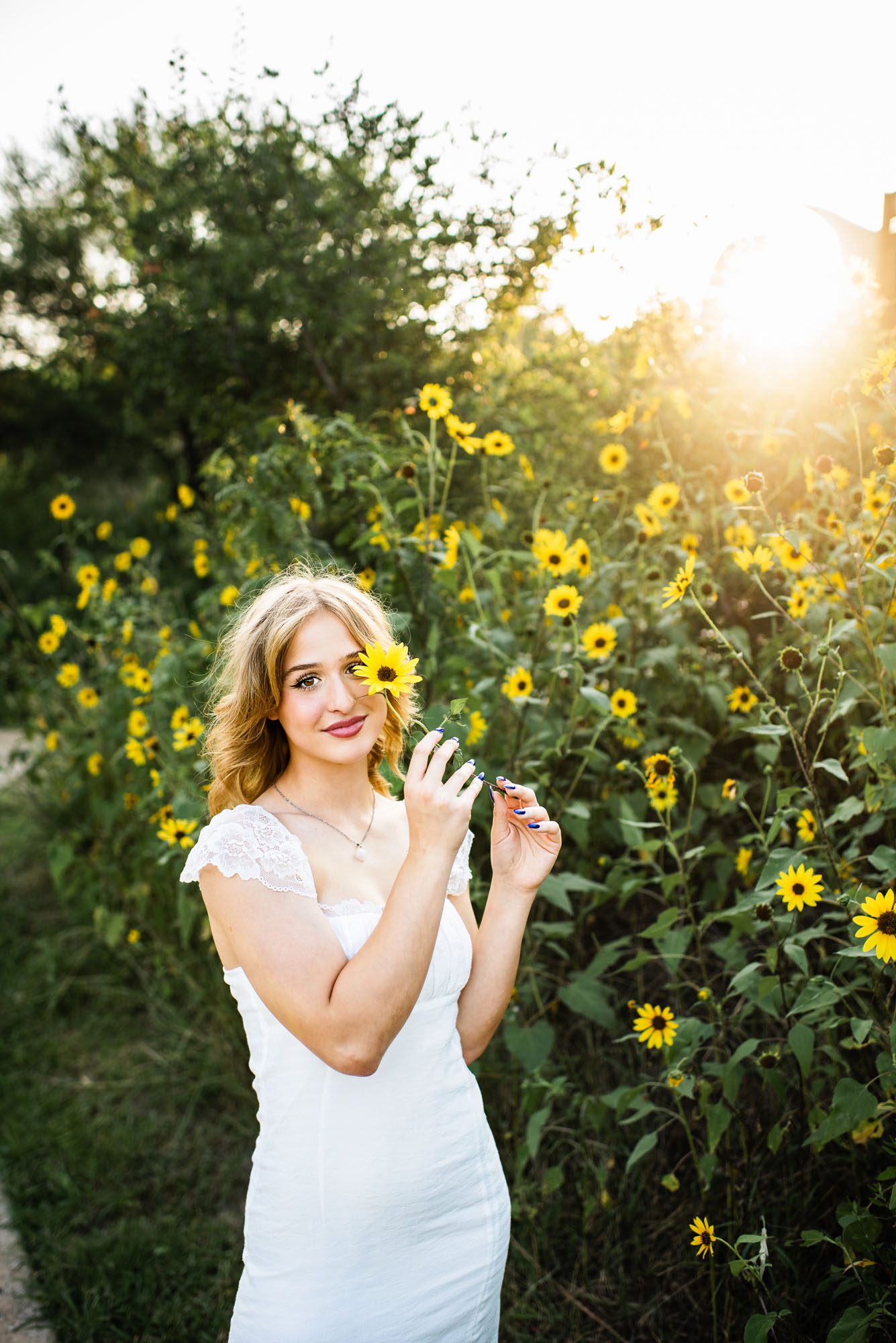 Girl holding sunflower over her eye, San Antonio senior photographer