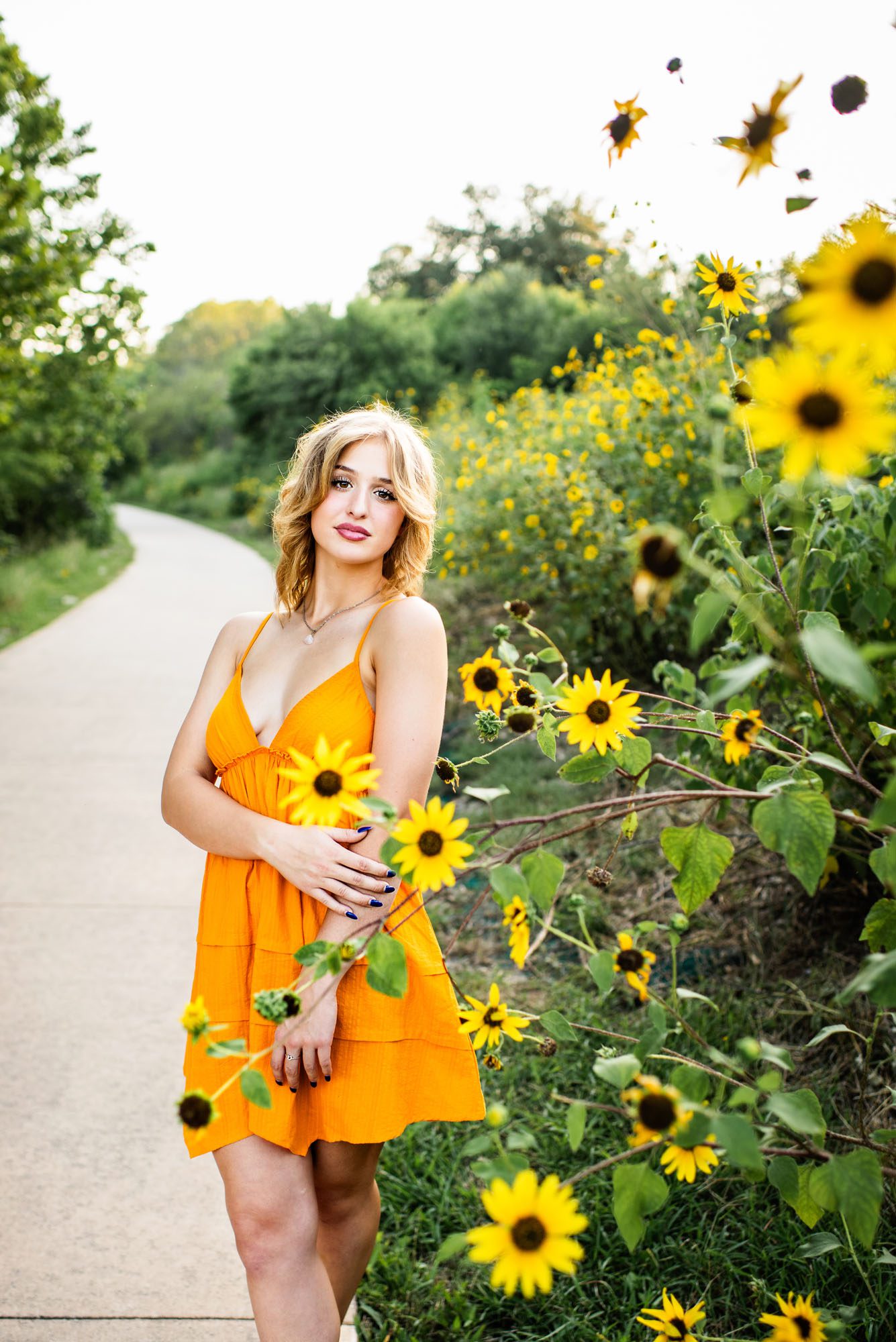 Girl standing in path by sunflower field, San Antonio senior photographer