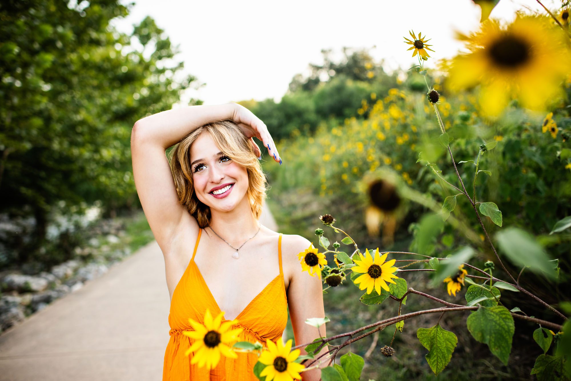 Senior girl standing by sunflower field, San Antonio senior photographer