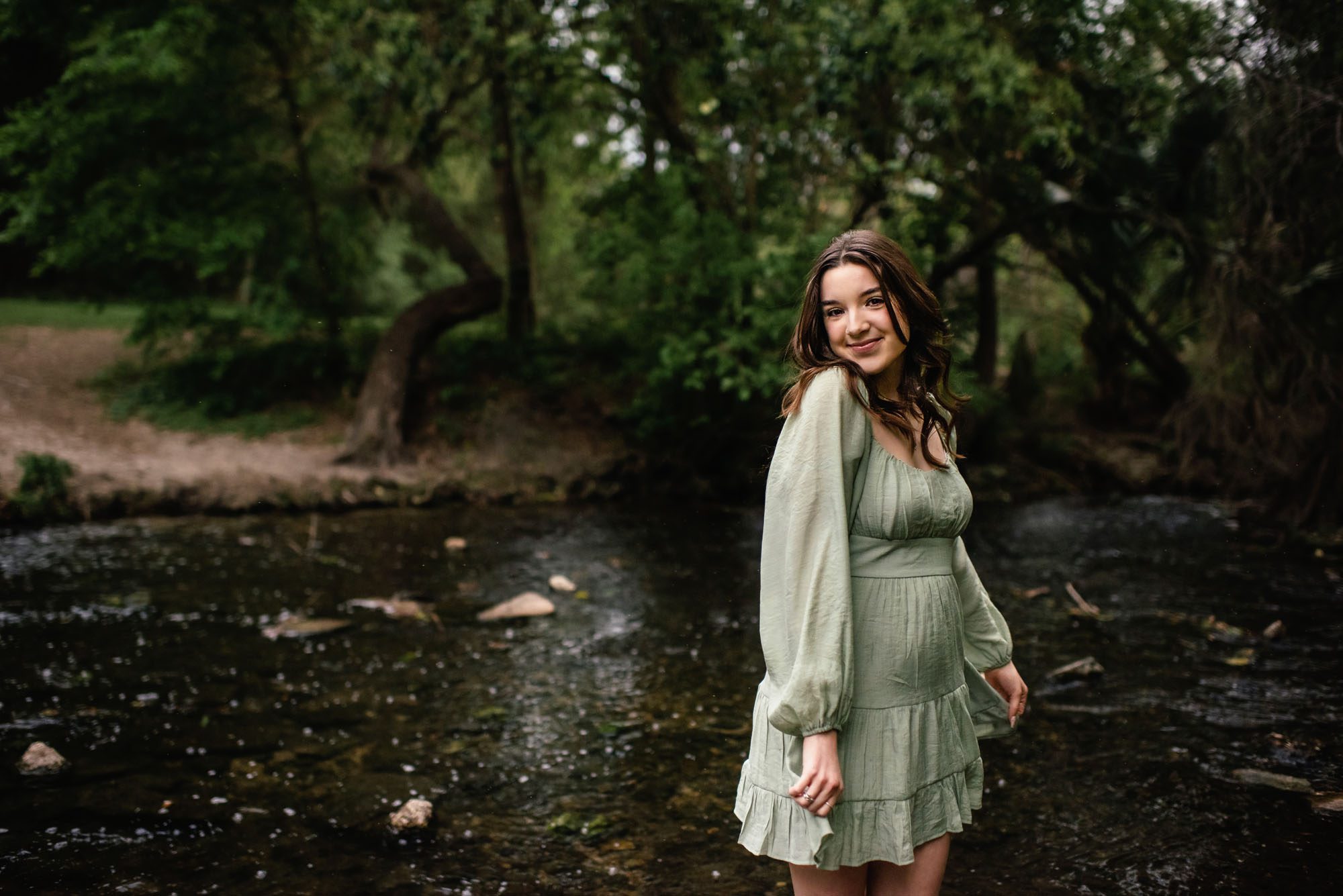 Girl standing in a shallow creek, San Antonio senior photographer