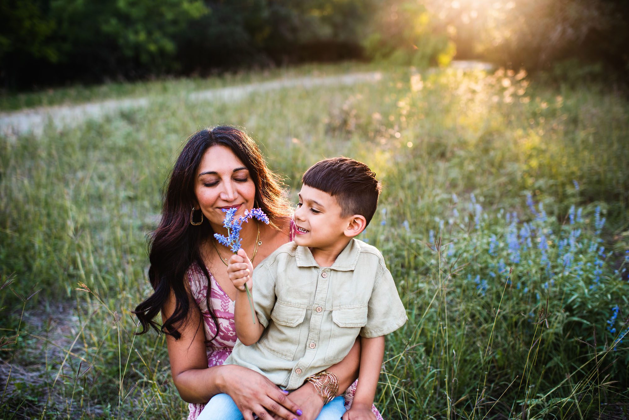 Mother and son smelling wildflowers, family photographer in San Antonio