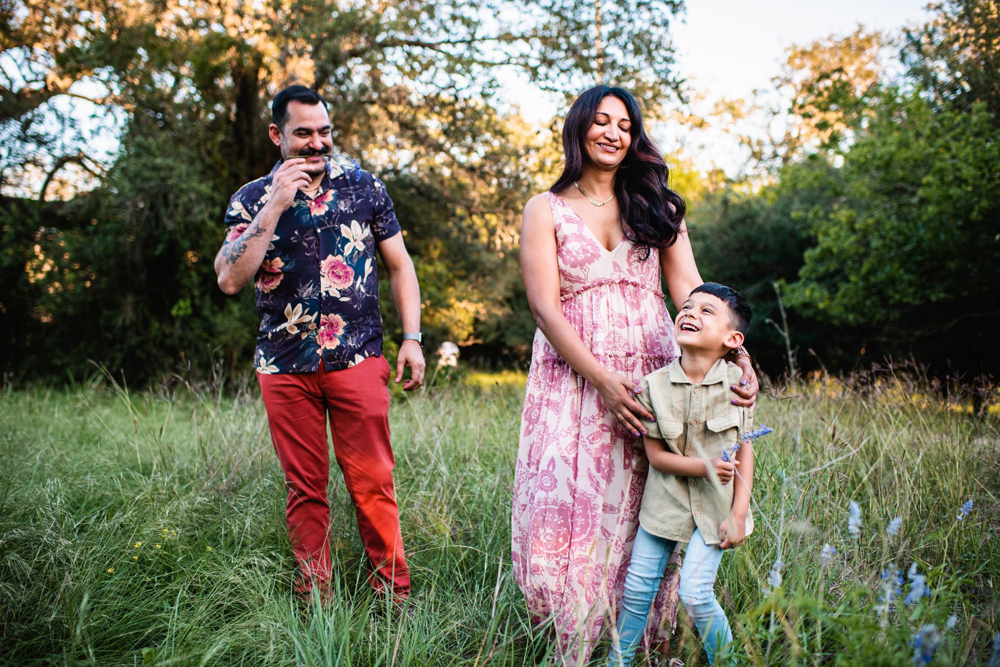 Family laughing in grassy field, San Antonio family photographer