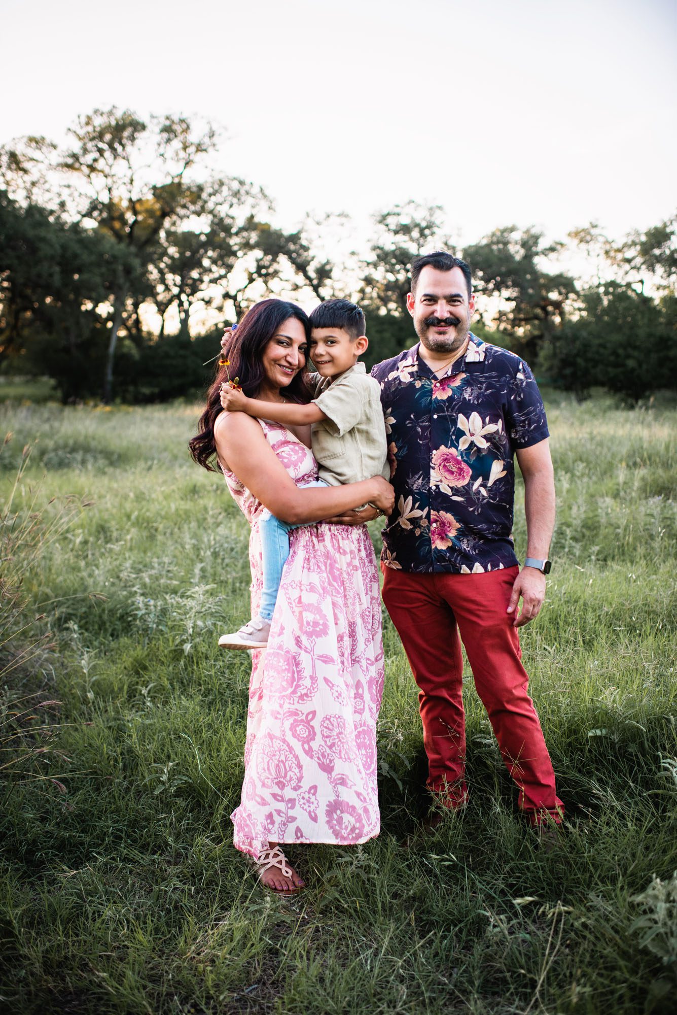 Family standing in grassy field, San Antonio family photographer