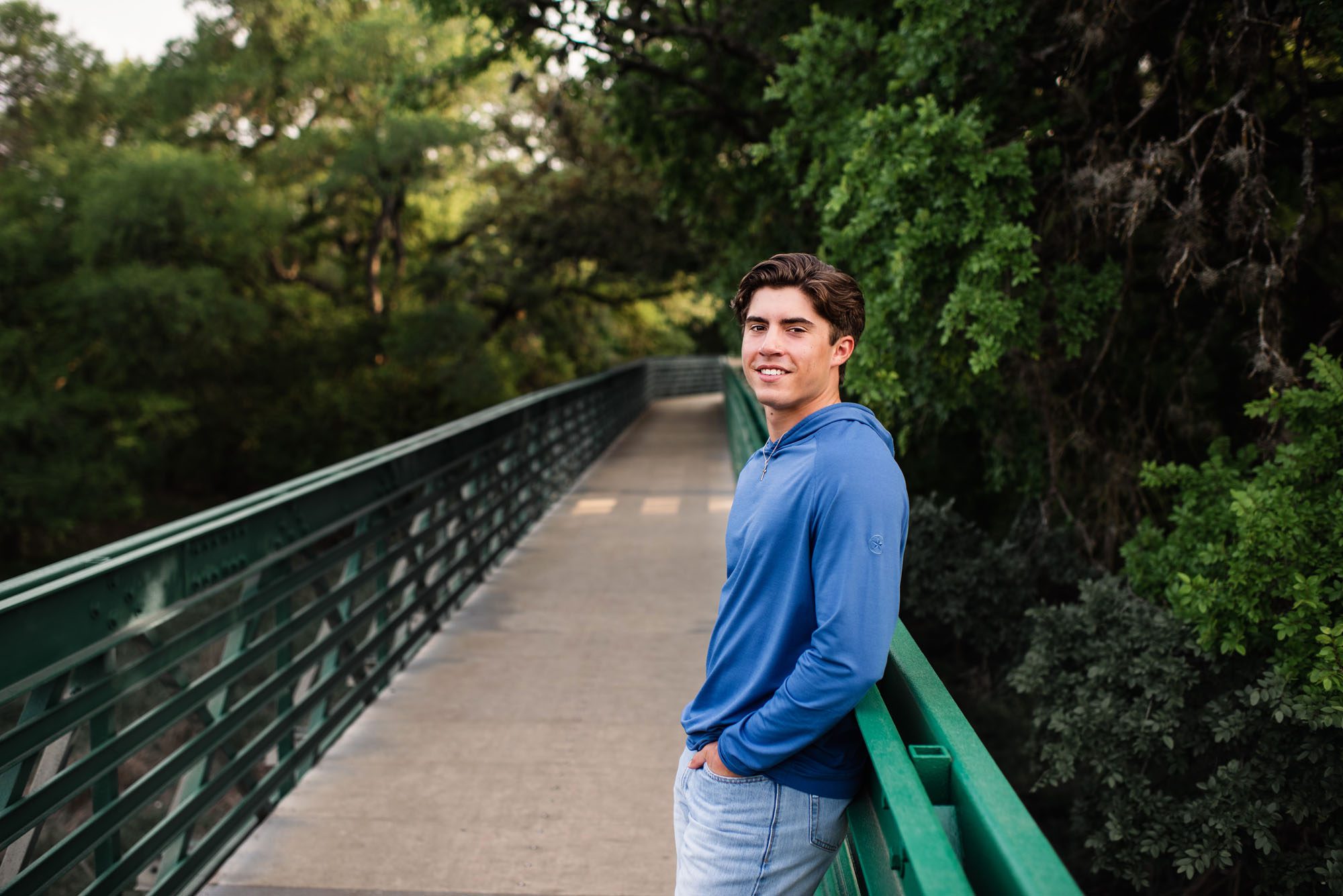 Boy leaning against bridge, San Antonio senior photographer