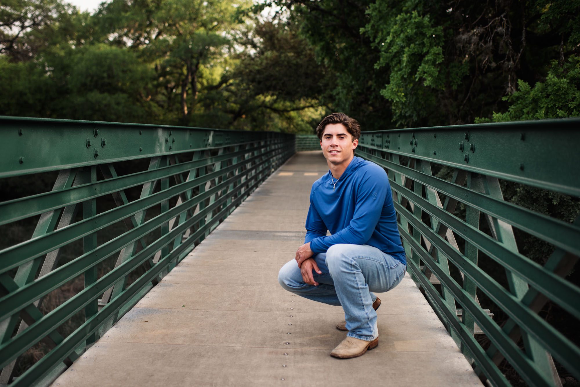 Boy squatting on bridge, San Antonio senior photographer