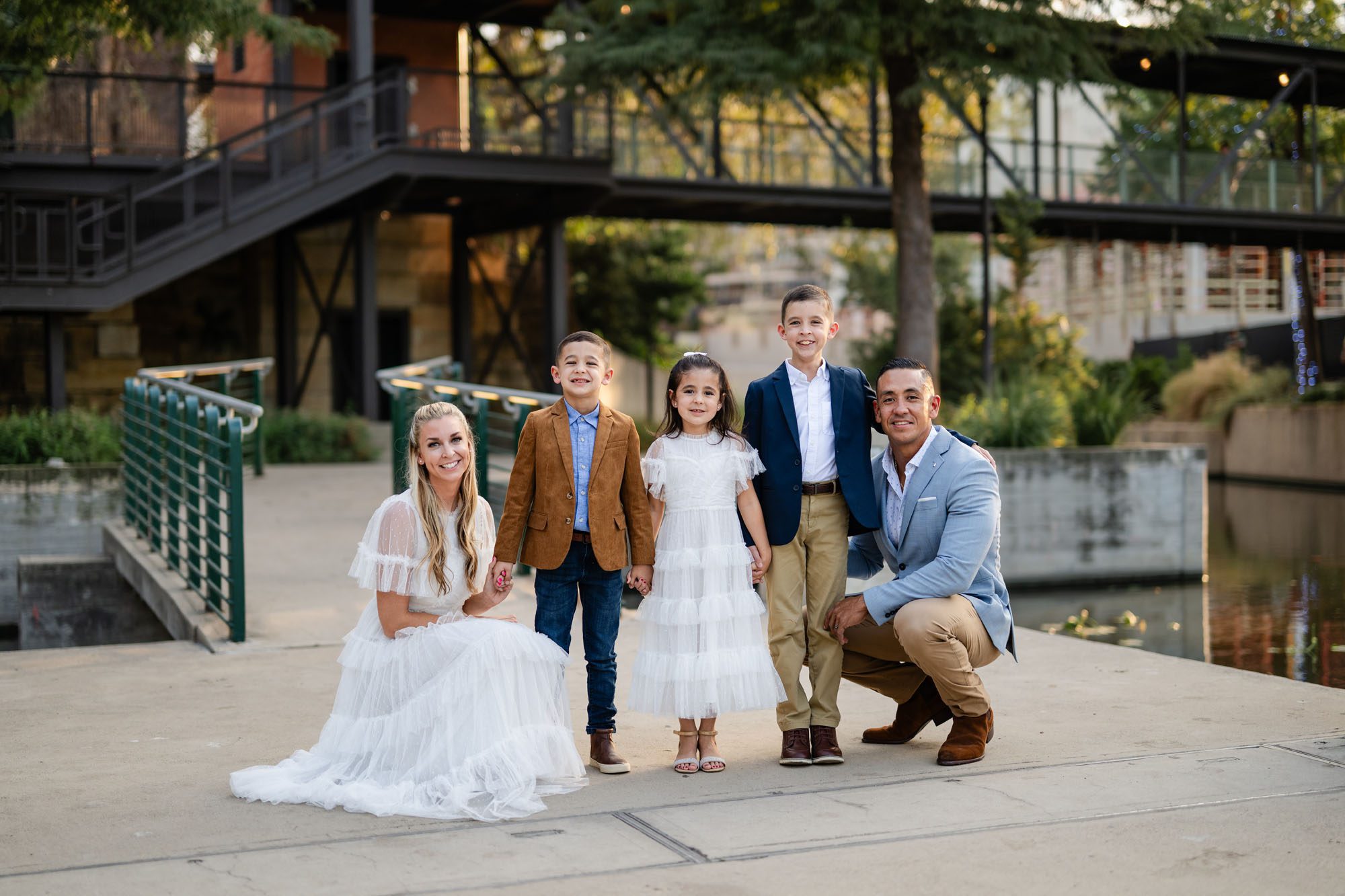 Family by a bridge on the Riverwalk at Pearl Brewery, San Antonio family photographer