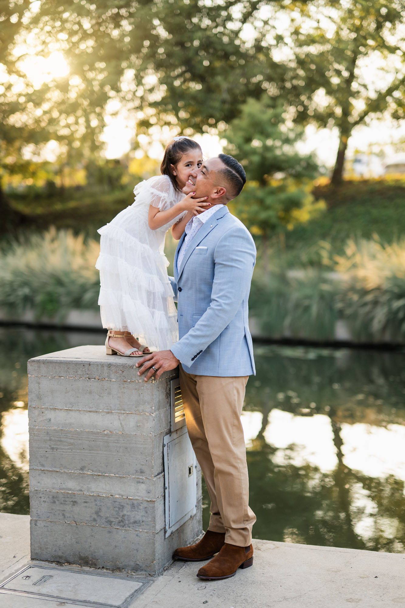 Little girl kissing father by the river, San Antonio family photographer