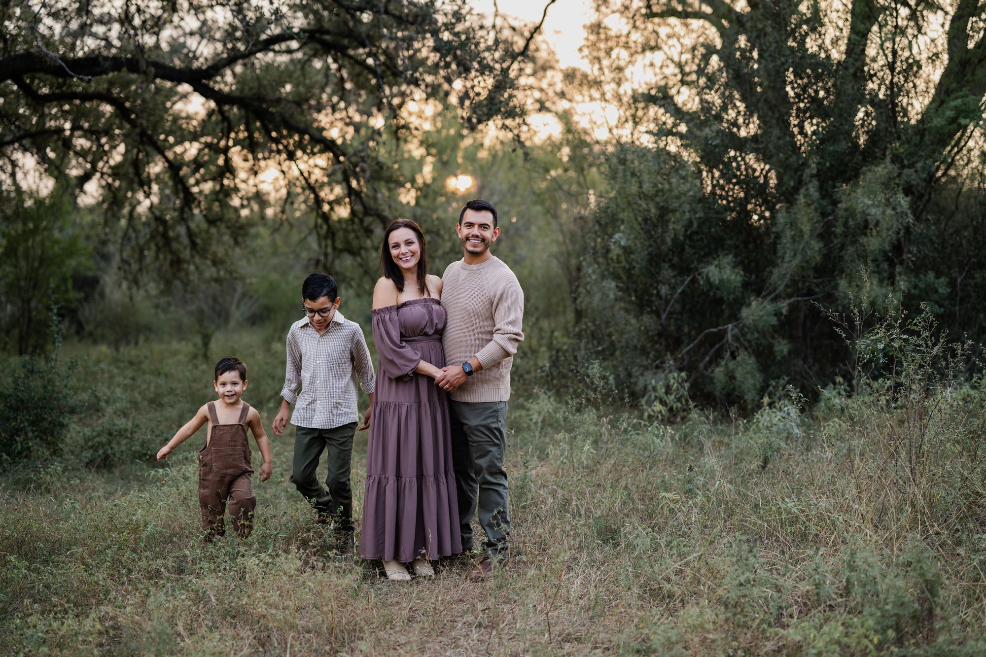 Family smiling while kids play, San Antonio family photographer