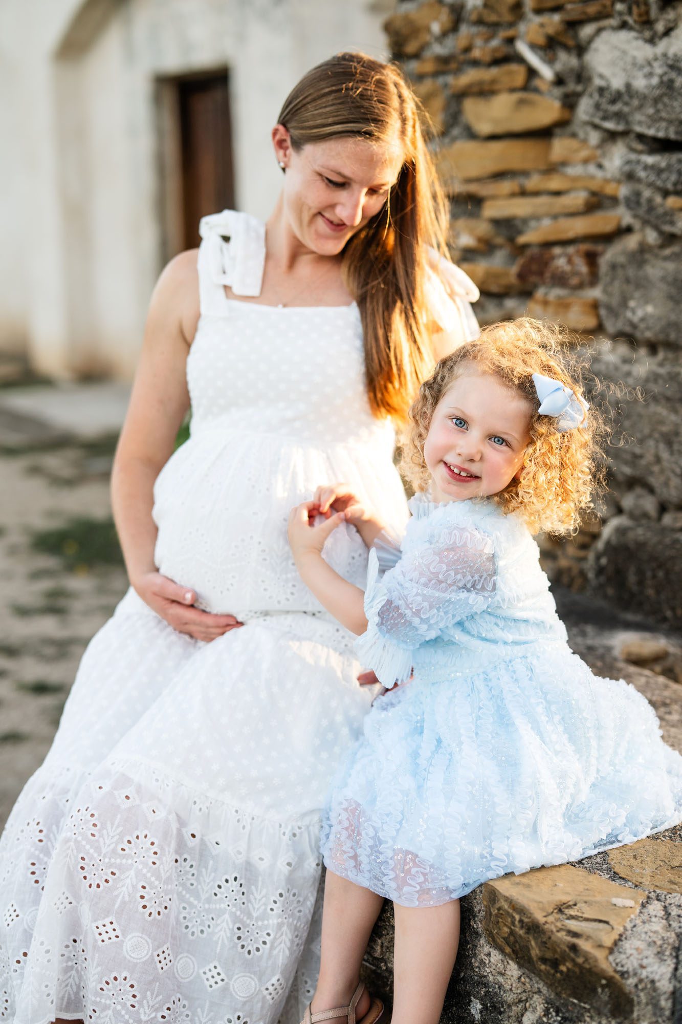 Little girl making heart on surrogate mother's belly, San Antonio surrogate maternity photographer
