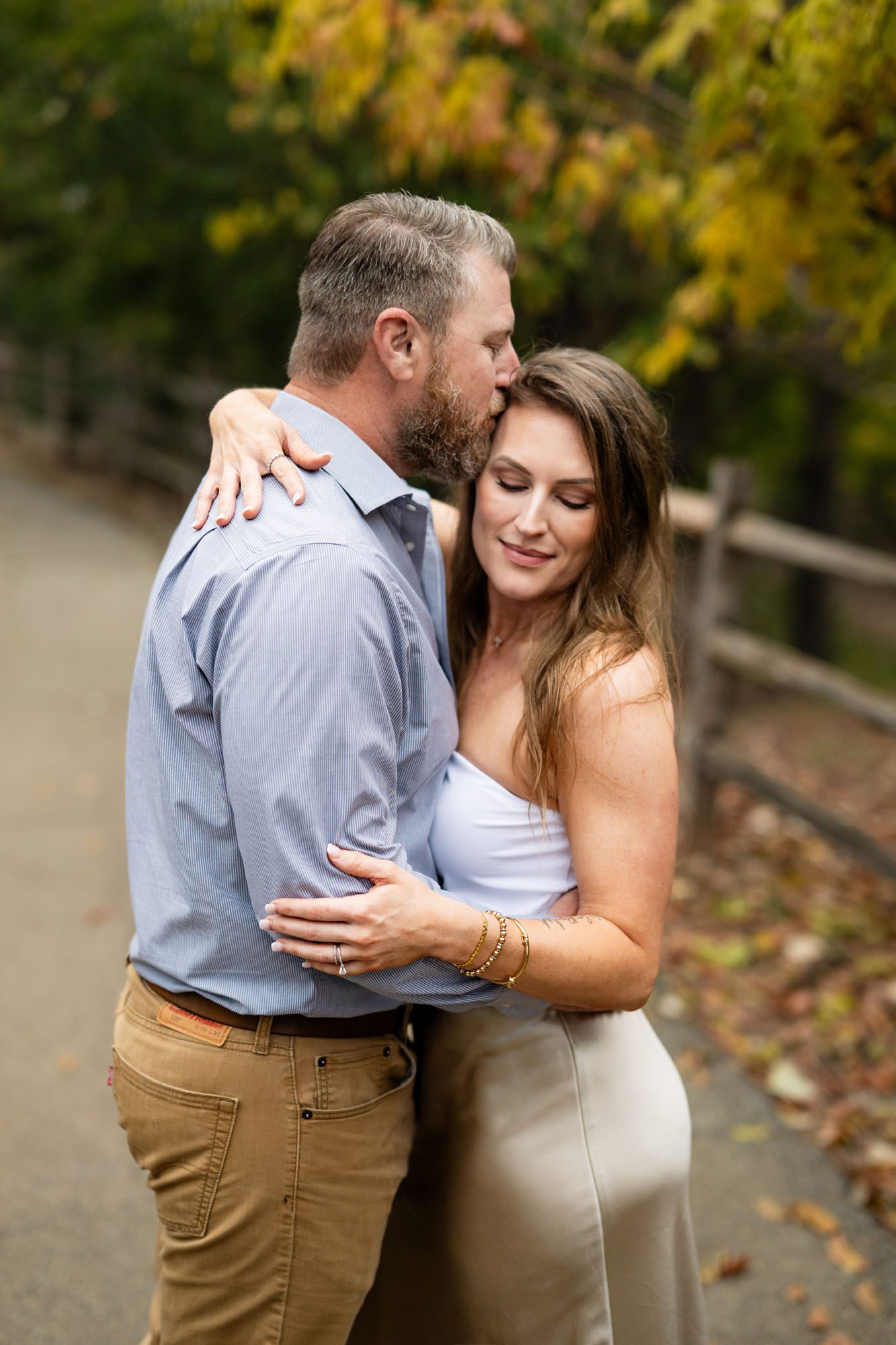 Husband kissing wife's forehead, San Antonio engagement photographer