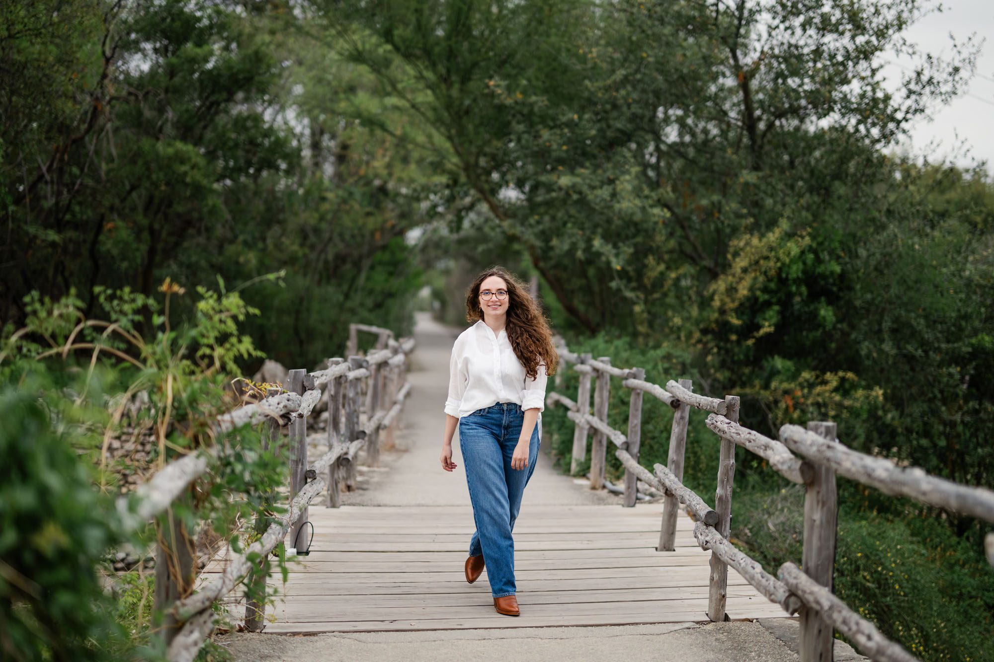 Girl in white shirt walking on bridge, San Antonio senior photography