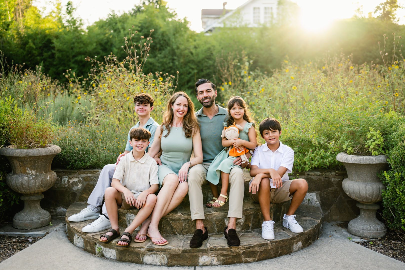 Family sitting together on steps at sunset, San Antonio family photographer