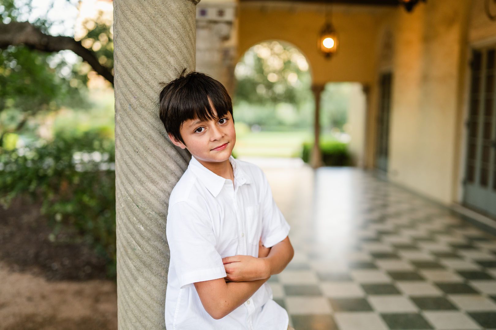 Little boy leaning against stone column, San Antonio family photographer