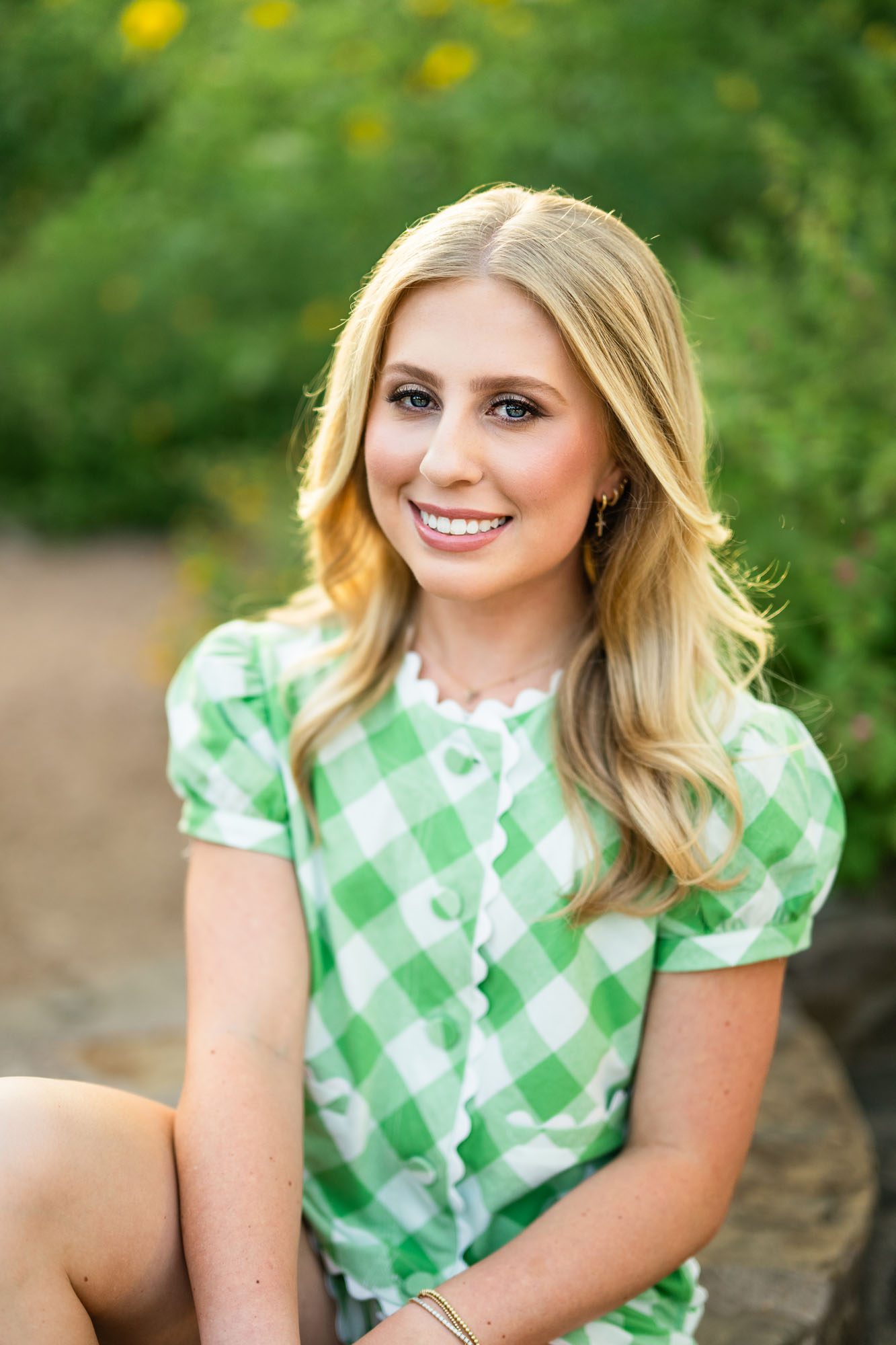 Teen girl sitting in garden with sunflowers, San Antonio senior photographer